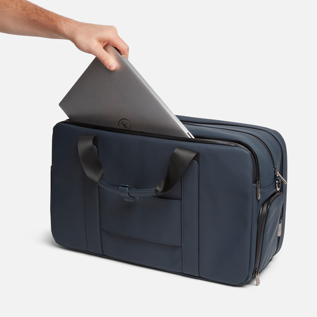 Men's laptop duffel bag with sleek navy design and padded compartment for secure tech transport.