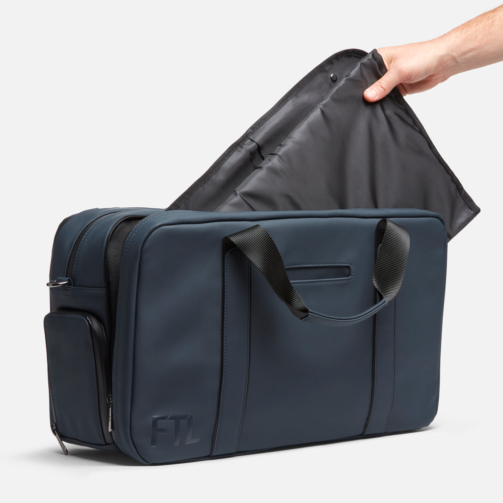 A duffel garment bag with fold-out interior lining and an FTL logo is designed for stylish and functional travel organization. Abbot Green,Kenmare Black,Essex Blue, Stone Grey