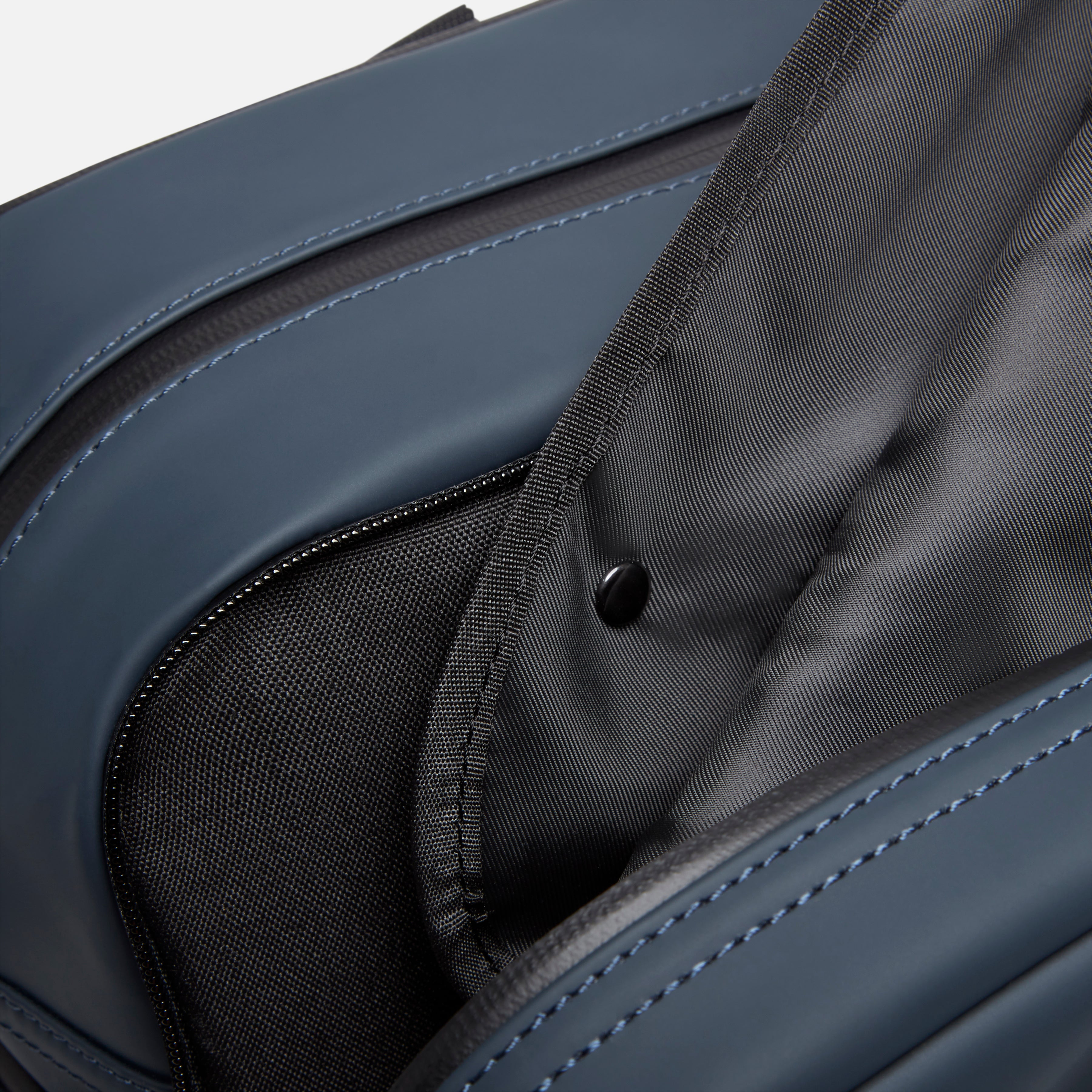 Garment duffel with interior compartments, blue exterior stitching, and durable lining for organized travel and clothing protection.
