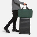 Men's duffle bag for travel in green with trolley sleeve, perfect for stylish and convenient airport or weekend trips.