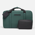 Black FTL dopp kit organizer beside a green water-resistant duffel with luggage tag.