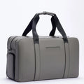 Gray FTL Max duffle bag with black carry straps and embossed logo, side angle.