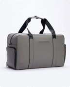 Grey FTL Lite duffel bag with black carry handles and side pocket for gym and work.