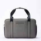 Grey FTL Lite duffel bag with black carry handles, shown front-on for gym and work.